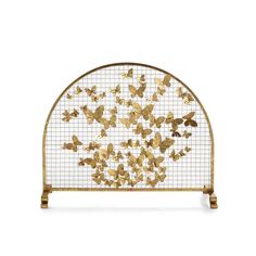 a gold metal headboard with lots of butterflies on the top and bottom, against a white background