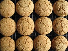 twelve cookies are on a cooling rack ready to be baked in the oven for consumption