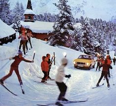 skiers and snowboarders are skiing down a snowy hill