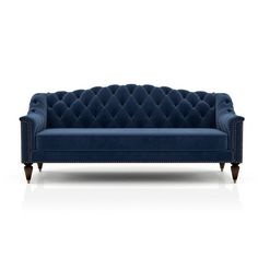 an image of a blue couch with buttons on it's arm and legs, in front of a white background