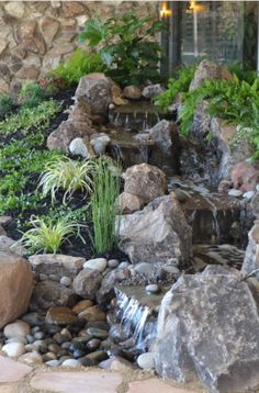 an outdoor garden with rocks and water features