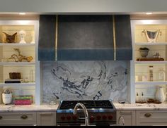 a stove top oven sitting inside of a kitchen next to white cupboards and shelves