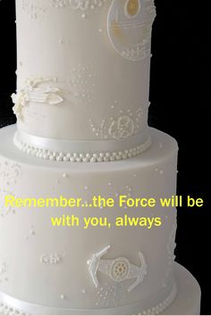 a three tiered white cake with the words remember the force will be with you, always