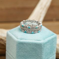 a stack of rings sitting on top of a blue box