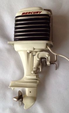 an old motor is attached to the side of a white wall mounted device on a white sheet