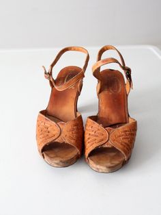 This is a pair of 1970s vintage Nobil's leather sandals. The brown leather open toe slingbacks have wooden heels. Buckle closure at ankle. Marked Made in Brazil.CONDITIONIn good condition with wear consistent with age and use. Small chip in the wood at the top of the heels. APPROXIMATE FIT: 10B USMEASUREMENTSInsole Length: 10.5" .. 26.7 cmWidth: 3" .. 7.6 cmHeel: 3.75" .. 9.5 cm92225Women’s sandals. Good condition, size 10. Detailed measurements:Length Of Sole - 10.5 inchesHeel Height - 3.75 inches Wooden Heels, Plaid Coat, Wooden Heel, Vintage Plaid, Scarf Print, Out Of Style, Women's Pumps, Vintage 70s, Leather Sandals