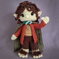 a small crocheted doll dressed in a costume