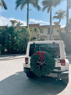 a white truck with a christmas wreath on the back