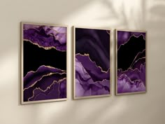 three paintings hanging on the wall in a room with white walls and purple marbles