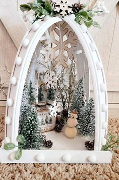 a christmas scene with snowflakes, trees and a polar bear in a white arch