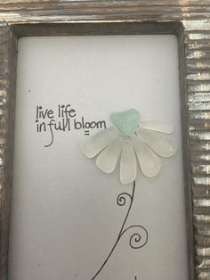 a frame with a flower in it and the words live life infull bloom