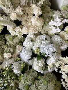 a bunch of white and green flowers on a table