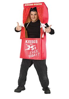 a man in a costume that has a red bag on his head and is holding a sign reading kisses free today