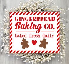 a red and white sign that says gingerbread baking co baked fresh daily with two teddy bears