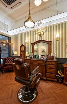 a barber chair sitting in front of a mirror on top of a hard wood floor