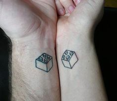 two people holding hands with tattoos on their arms and one has a dice tattoo on the wrist