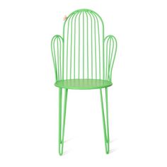 a green chair that is sitting in the middle of a white background with a bird perched on it's back