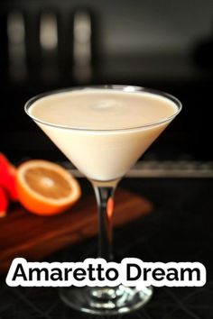 a martini glass with an orange slice on the side and text that reads amaretto dream