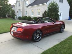 a red sports car parked in front of a house