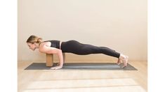 a woman is doing yoga on a mat