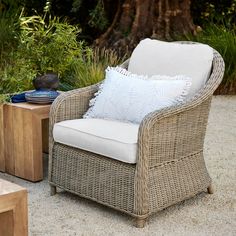 a wicker chair sitting on top of a cement ground