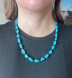 Vibrant, Southwestern, and versatile beaded American Turquoise & Brown Shell necklace that is handcrafted by me! This necklace is lightweight and comfortable, making it ideal for everyday wear. It adds a pop of color and a Southwestern vibe to your outfit. You can pair this simple Turquoise necklace with anything. It would be a beautiful addition to your outfit! The stones are genuine American Turquoise and Brown Shell. All findings are 925 sterling silver. Measurements: 22" long with 10mm genui Southwestern Single Strand Turquoise Necklace, Southwestern Turquoise Gemstone Beads Necklace, Southwestern Style Large Beads Turquoise Necklace, Adjustable Southwestern Turquoise Necklace Hand-strung, Southwestern Adjustable Turquoise Necklace Hand-strung, Adjustable Southwestern Hand-strung Turquoise Necklace, Southwestern Adjustable Hand-strung Turquoise Necklace, Southwestern Style Adjustable Hand-strung Turquoise Necklace, Southwestern Turquoise Beaded Necklace For Healing