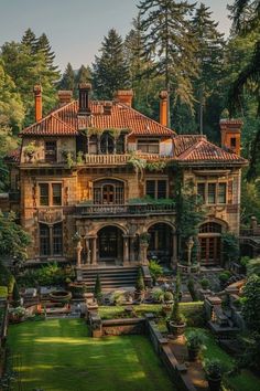 an old style house in the middle of a lush green field with lots of trees