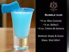 a blue curacao in a glass on a table