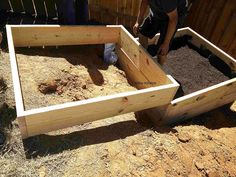 a man is building a raised garden bed