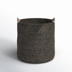 a black and white basket with two horns on the top, sitting in front of a white background