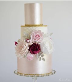 a white and pink wedding cake with flowers on the top is featured in an instagram