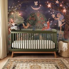 a baby's room decorated with fairy themed wallpapers and a green crib