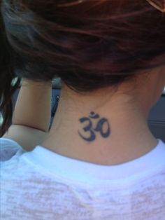 a woman with a tattoo on her neck that has an omen symbol on it