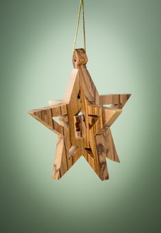 a wooden star ornament hanging from a string