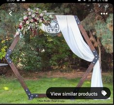 a wedding arch decorated with flowers and greenery