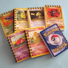 the pokemon notebooks are lined up next to each other