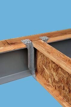 a close up of a wooden frame with metal brackets on the bottom and side panels