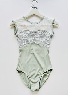 a woman's bodysuit hanging on a hanger, with the top half cut off