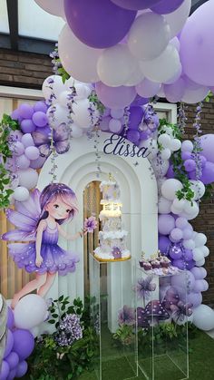 a birthday party with purple and white balloons, cake and fairy figurines on display