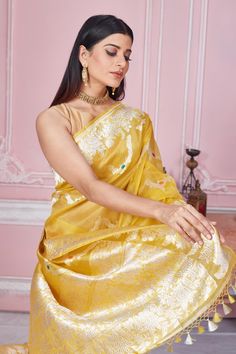 Radiate elegance on special occasions in this beautiful yellow Banarasi sari with zari minakari work. It comes with a blouse piece. Disclaimer: The shown stitched blouse on the model is for display purpose only. The saree comes with a matching blouse piece and finished with fall and piko. Designer Pre-draped Yellow Saree, Yellow Designer Wear Pre-draped Saree, Yellow Pre-draped Designer Saree, Transitional Designer Yellow Pre-draped Saree, Transitional Yellow Tissue Silk Pre-draped Saree, Designer Yellow Saree For Navratri, Pre-draped Meenakari Saree For Puja, Yellow Katan Silk Pre-draped Saree, Yellow Designer Saree For Diwali