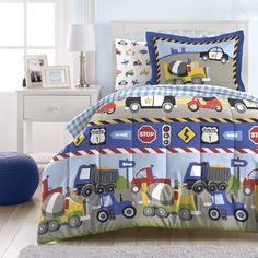 a child's bed with construction vehicles on it