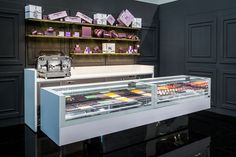 a display case in the middle of a room filled with chocolates and other items