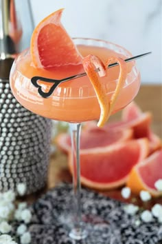 a grapefruit cocktail garnished with an orange slice