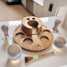 a wooden brush holder sitting on top of a counter next to some other items that are around it