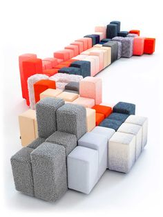 an arrangement of different colored cubes arranged in the shape of a long line on a white background