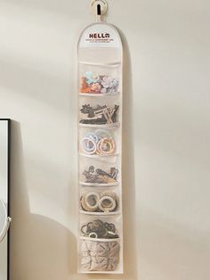 a white wall hanging organizer filled with lots of items