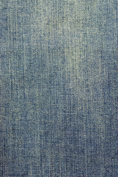 an image of blue denim fabric textured with natural dyes and staining on it