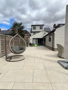 a patio with two chairs and a hammock