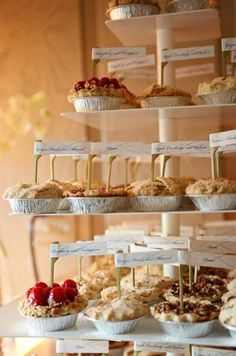 three tiered trays filled with different types of pastries and desserts on top of each other