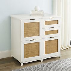 a white cabinet with wicker baskets on top